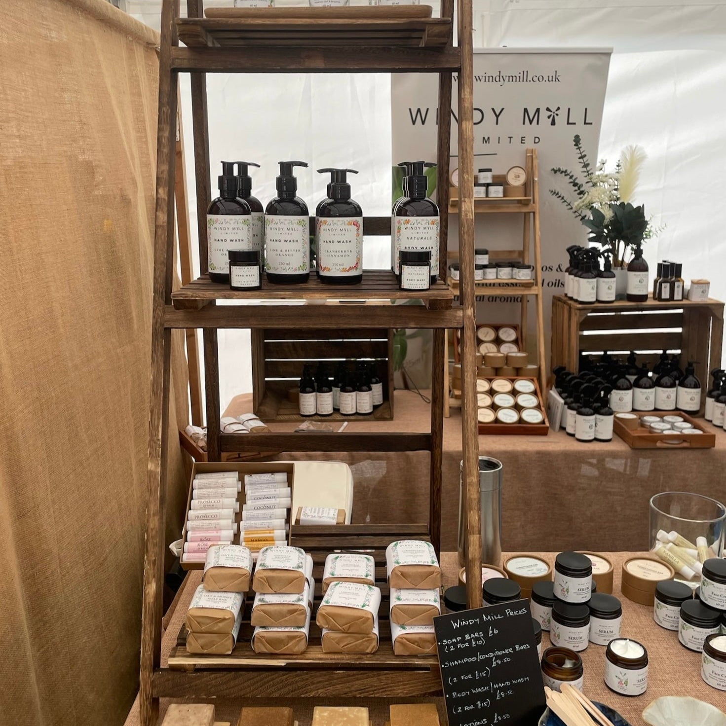 Wooden shelf with various products at a trade show booth.